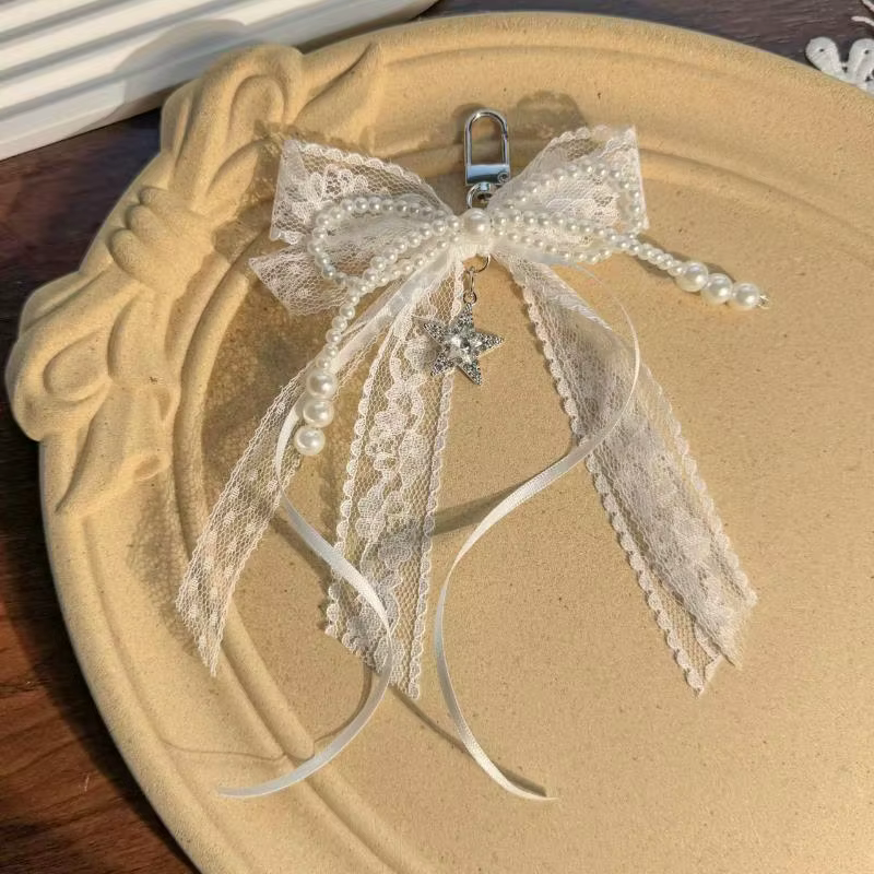 Porte-clés cadeau mignon pour la Saint-Valentin, nœud en dentelle avec chaîne de perles et breloque étoile. Accessoire de sac en ruban de ballet pour femme