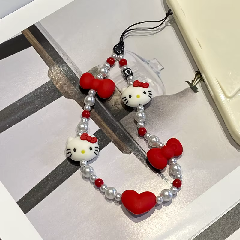 Cordon de téléphone Kawaii Hello Kitty avec nœud et perles pour appareil photo, accessoire de téléphone tendance pour fille 2026