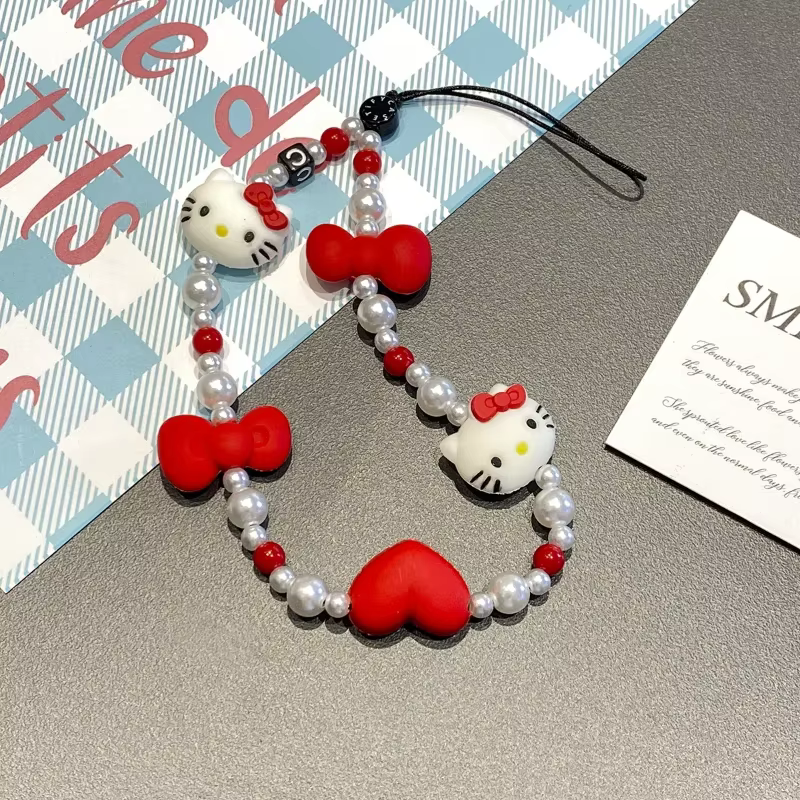 Cordon de téléphone Kawaii Hello Kitty avec nœud et perles pour appareil photo, accessoire de téléphone tendance pour fille 2026